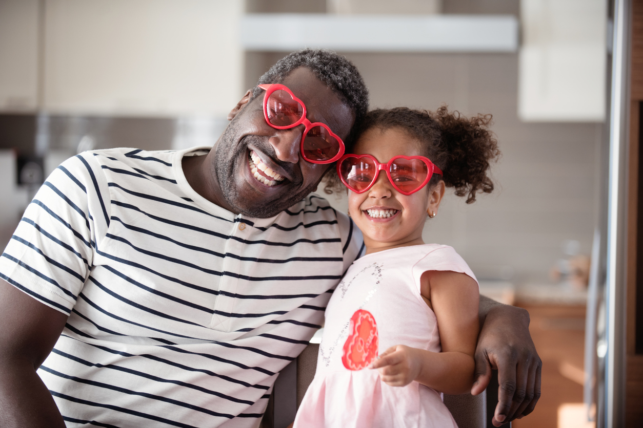 Father and Daughter in Red Glasses Smiling